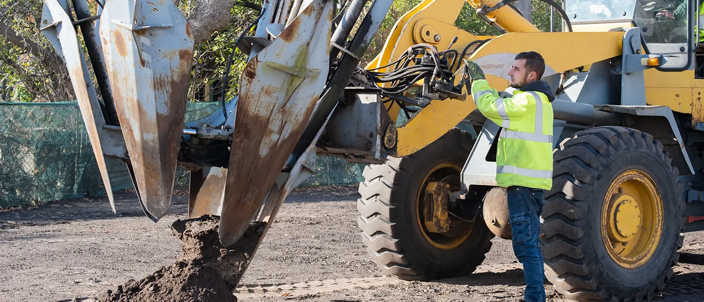 Technician troubleshooting hydraulic issues in tree spades